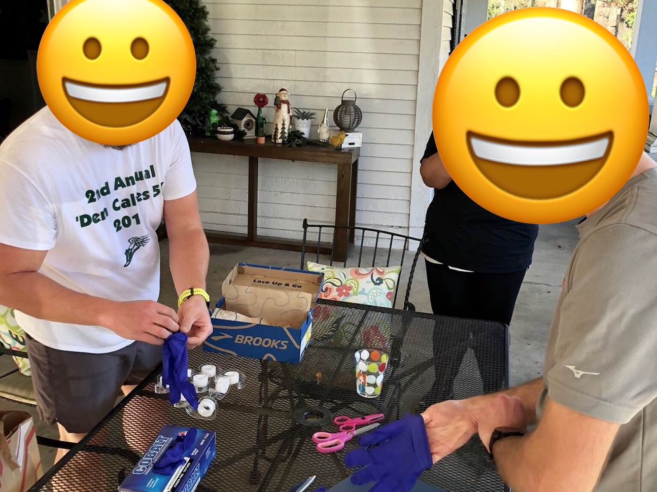 Two sweaty dudes race to wrap presents while wearing large latex gloves.