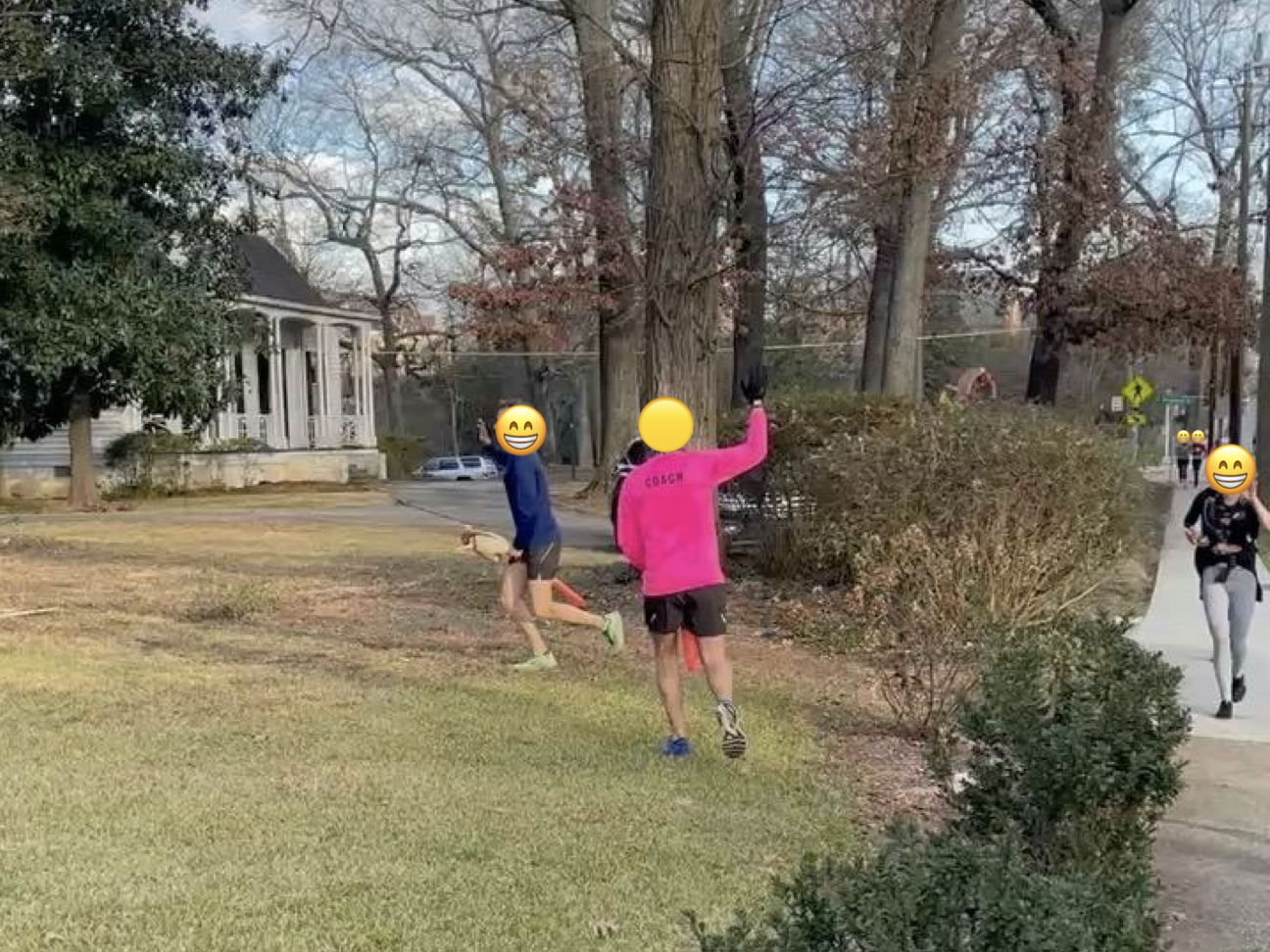 Two people galloping on inflatable horses and waving.